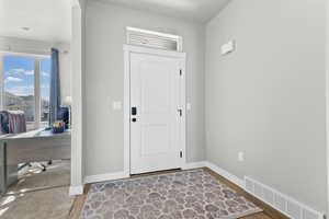 Foyer entrance with baseboards and light wood finished floors