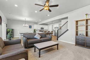 Living area featuring ceiling fan, recessed lighting, and light colored carpet