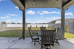 Fenced backyard with a patio area and outdoor dining area
