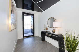 Foyer entrance featuring baseboards and wood finished floors