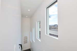 Corridor featuring recessed lighting and baseboards