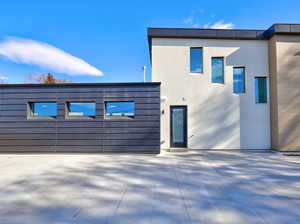 View of front of property featuring stucco siding and a patio area