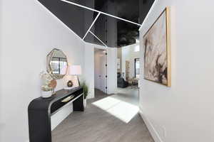 Entry with a high ceiling and light wood-style floors