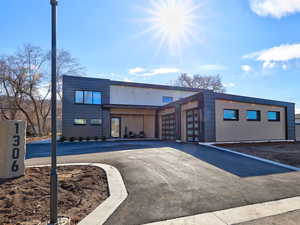 View of building exterior with an attached garage and driveway