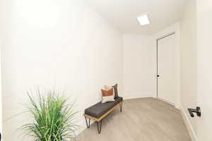 Living area featuring baseboards and light wood finished floors