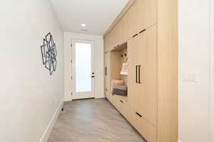 Mudroom with light wood-style flooring and recessed lighting