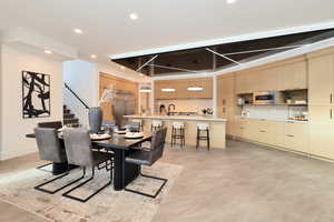 Dining space featuring stairs and recessed lighting