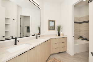 Full bathroom featuring double vanity and toilet