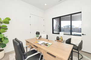Home office with recessed lighting and baseboards
