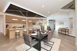 Dining space featuring a high ceiling, recessed lighting, and a ceiling fan