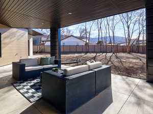 Fenced backyard featuring a patio area, an outdoor lounge area, and a mountain view