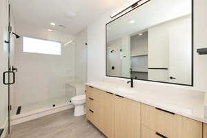 Bathroom with vanity, a shower stall, and recessed lighting