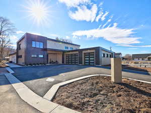 Contemporary house featuring an attached garage and driveway