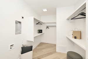 Walk in closet featuring light wood finished floors