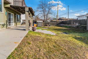 Fenced backyard with a patio