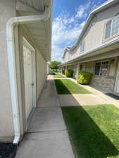 View of side of property featuring stucco siding and a lawn
