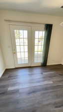 Entryway with wood finished floors and french doors