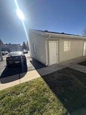 View of home's exterior featuring stucco siding and a yard