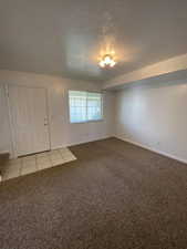 Spare room featuring baseboards and light carpet