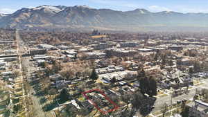 View of property location with property parcel outlined, mountains, and nearby suburban area