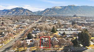 Aerial view of residential area featuring property boundaries highlighted and mountains