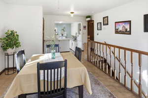 Dining space with light tile patterned floors and baseboards