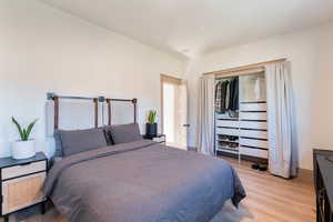 Bedroom featuring light wood-type flooring and baseboards