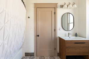 Full bathroom with vanity and shower / bath combination with curtain