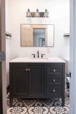 Bathroom with vanity and light tile patterned floors