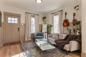 Living room with wainscoting and light wood-type flooring