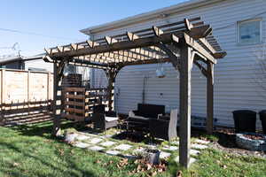 Fenced yard featuring a patio, an outdoor living space with a fire pit, and a pergola