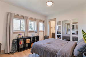 Bedroom featuring light wood-style flooring and ensuite bathroom