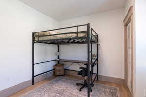 Bedroom featuring light wood-type flooring and baseboards
