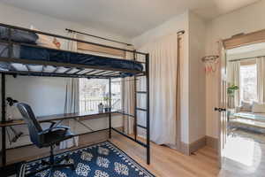 Bedroom featuring an office area and light wood-style floors