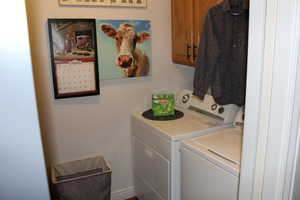 Laundry room with washing machine and clothes dryer and cabinet space