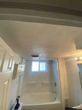 Bathroom featuring washtub / shower combination