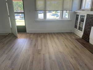 Unfurnished living room with wood finished floors
