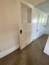 Detailed view of baseboards and carpet flooring