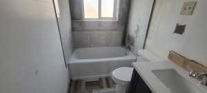 Bathroom with a tub and vanity