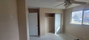 Unfurnished bedroom with a closet and a ceiling fan