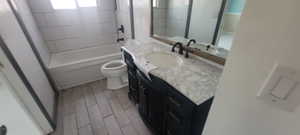 Full bath featuring vanity, shower / bath combination, and wood finish floors