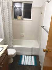 Full bath featuring vanity and shower / bath combo with shower curtain