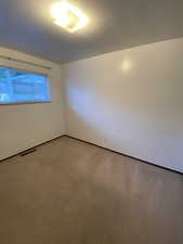 Unfurnished room with light colored carpet