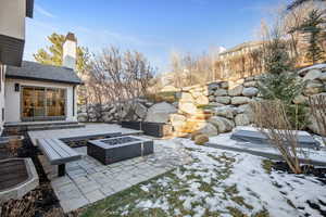 View of patio with a fire pit