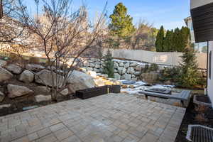 View of patio with an outdoor fire pit