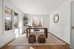 Office space featuring wood-type flooring and recessed lighting