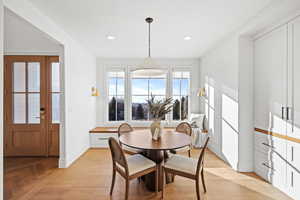 Dining area with light wood-type flooring and recessed lighting