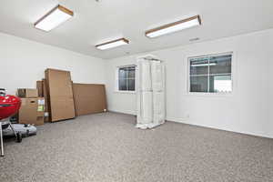 Empty room featuring plenty of natural light and light colored carpet
