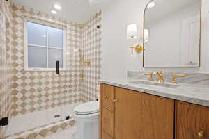 Full bathroom with vanity, a shower stall, and recessed lighting
