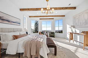 Carpeted bedroom with hanging lights and baseboards